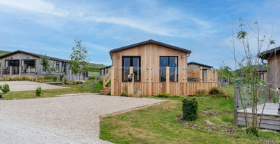 External of a luxury lodge on pitch with decking