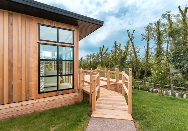 External of a luxury lodge on pitch with decking and walkway