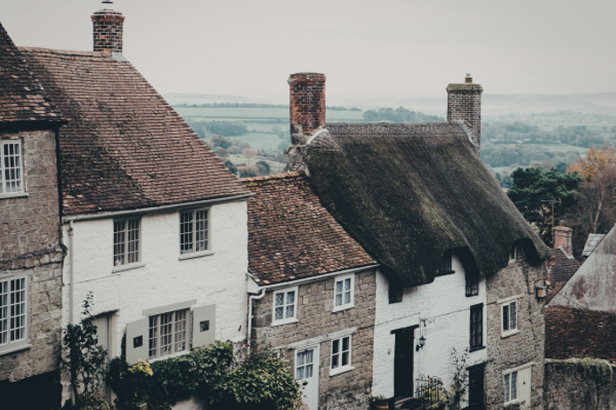 A row of cottage houses on a hill among countryside