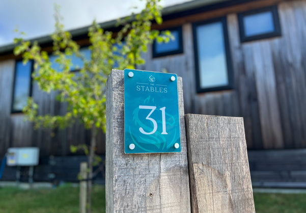 External of a luxury lodge on pitch with EV charging 