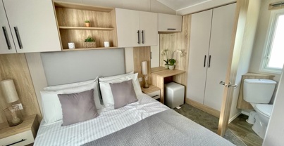 Internal of a caravan master bedroom with ensuite and storage