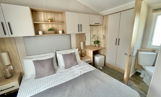 Internal of a caravan master bedroom with ensuite and storage