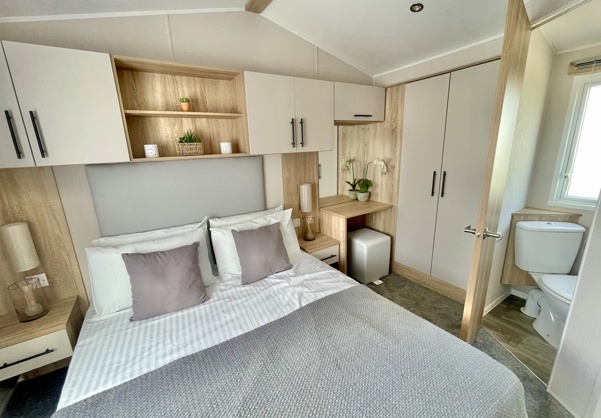 Internal of a caravan master bedroom with ensuite and storage