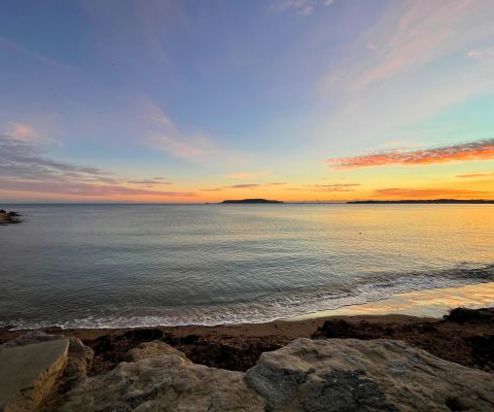 View of Bowleaze Cove at sunset