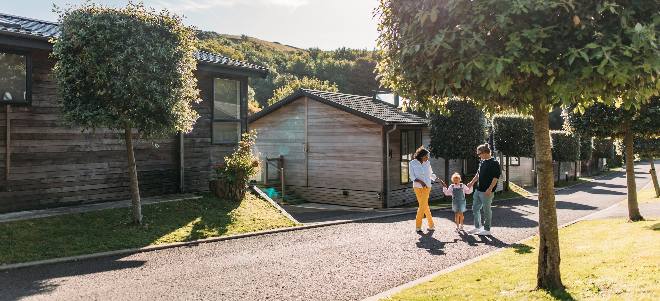 Family walking through Osmington Mills Lodge Park