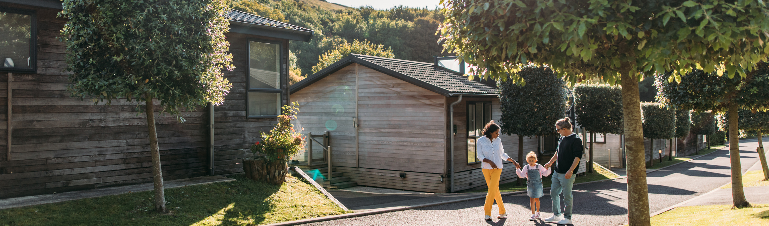 Family walking through Osmington Mills Lodge Park