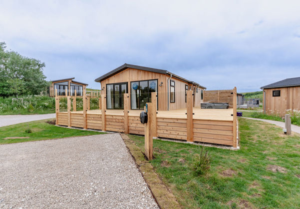 External of a luxury lodge on pitch with decking