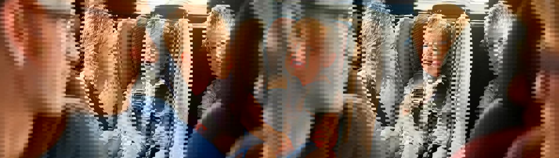 A family of five sat in a car together with the children looking distressed and bored