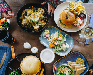 A selection of dishes from The Country Club including pie, sandwiches, burger, prawns and linguini