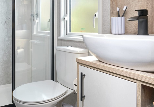 Internal of a caravan bathroom with shower, sink and toilet