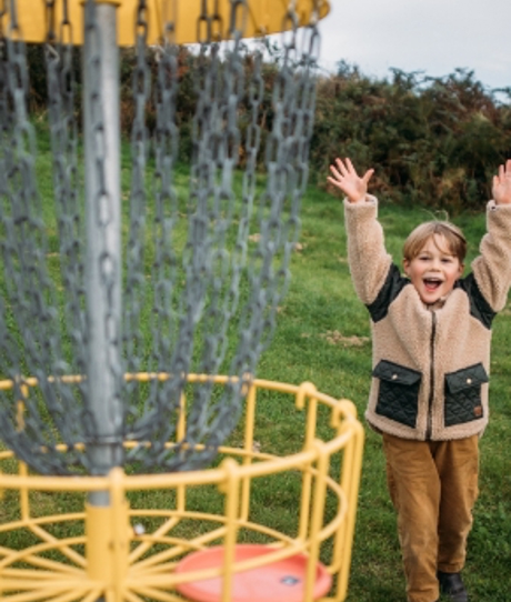 Young boy celebrating playing frisbee golf