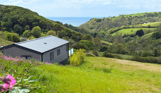 View of the sea from an area of Tregoad Holiday Park within the countryside valley