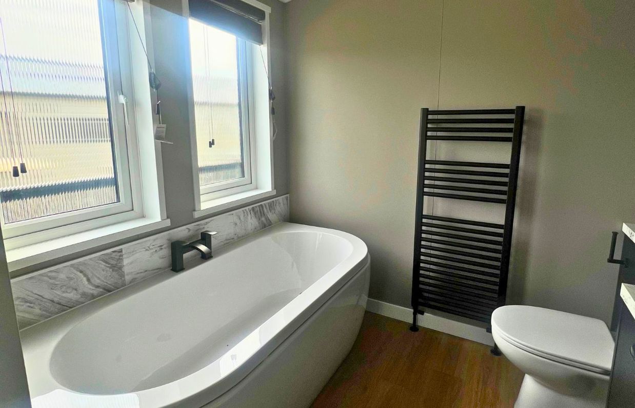 Internal of a lodge bathroom with bath and toilet