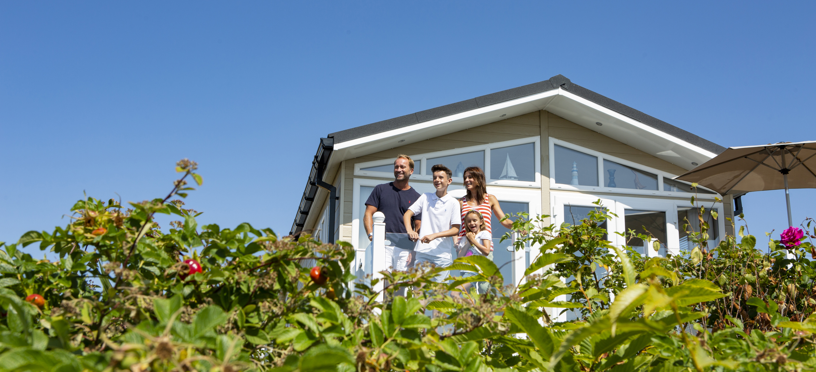 Family on deck of Chesil Beach Holiday Home
