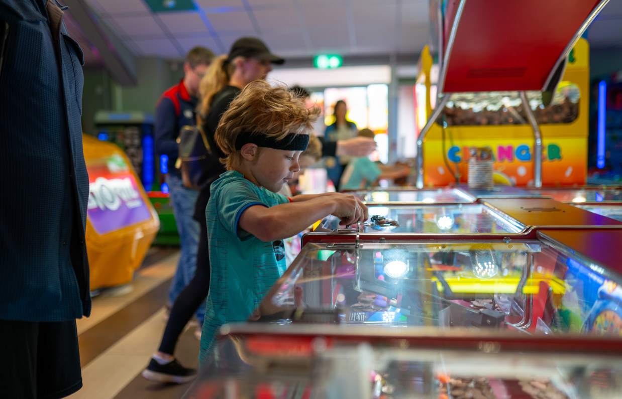 A young boy at the penny machines in Southside Arcade