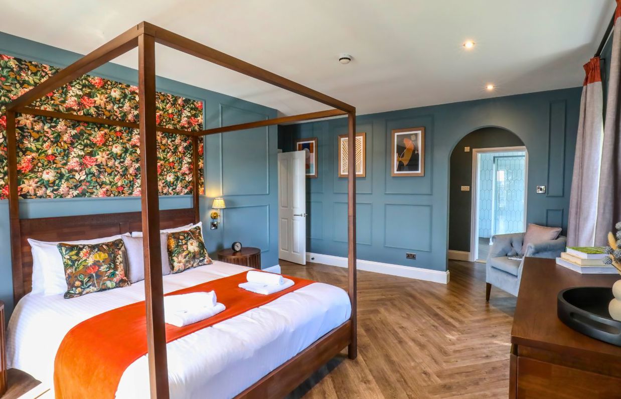 Internal of a manor house master bedroom with four poster bed and ensuite