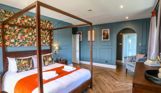Internal of a manor house master bedroom with four poster bed and ensuite
