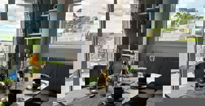 Dining table with L-shaped banquet seating set for dinner for four