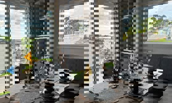 Dining table with L-shaped banquet seating set for dinner for four