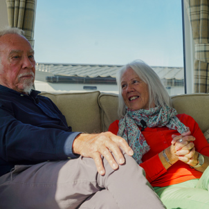 A couple sat together on a sofa