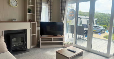 Internal of a caravan lounge area looking out to decking