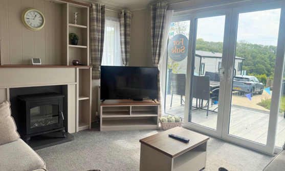 Internal of a caravan lounge area looking out to decking