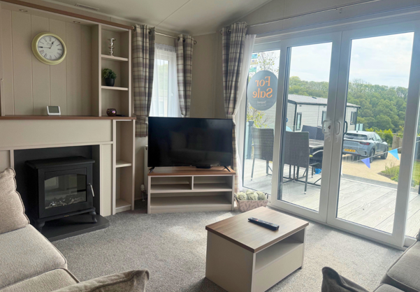 Internal of a caravan lounge area looking out to decking