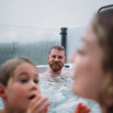 Dad watching kids have fun in hot tub