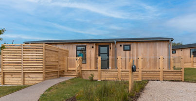 External of a luxury lodge on pitch with decking