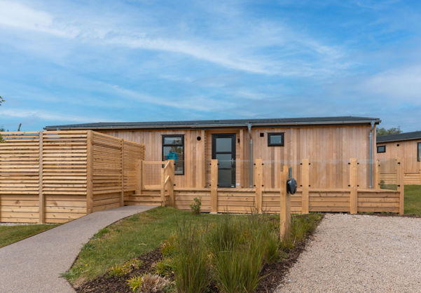 External of a luxury lodge on pitch with decking