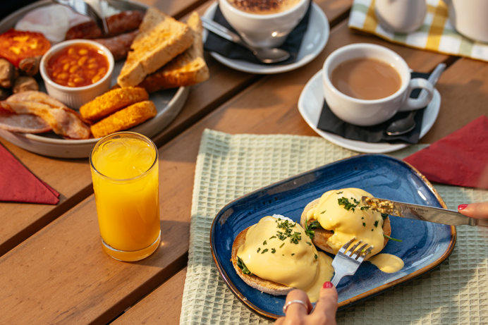 Two Breakfast Dishes with Hot Drinks and Orange Juice