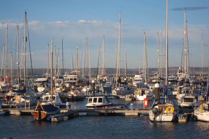 View of boats moored at Portland Marina and beyond
