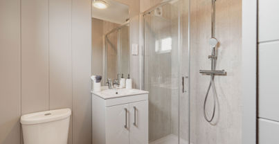Internal of a luxury lodge ensuite with walk-in shower, toilet and sink