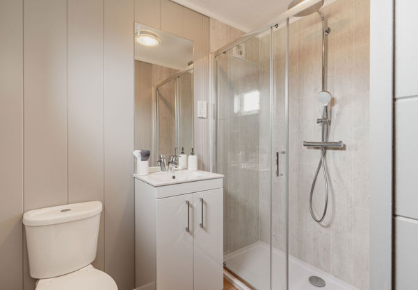 Internal of a luxury lodge ensuite with walk-in shower, toilet and sink