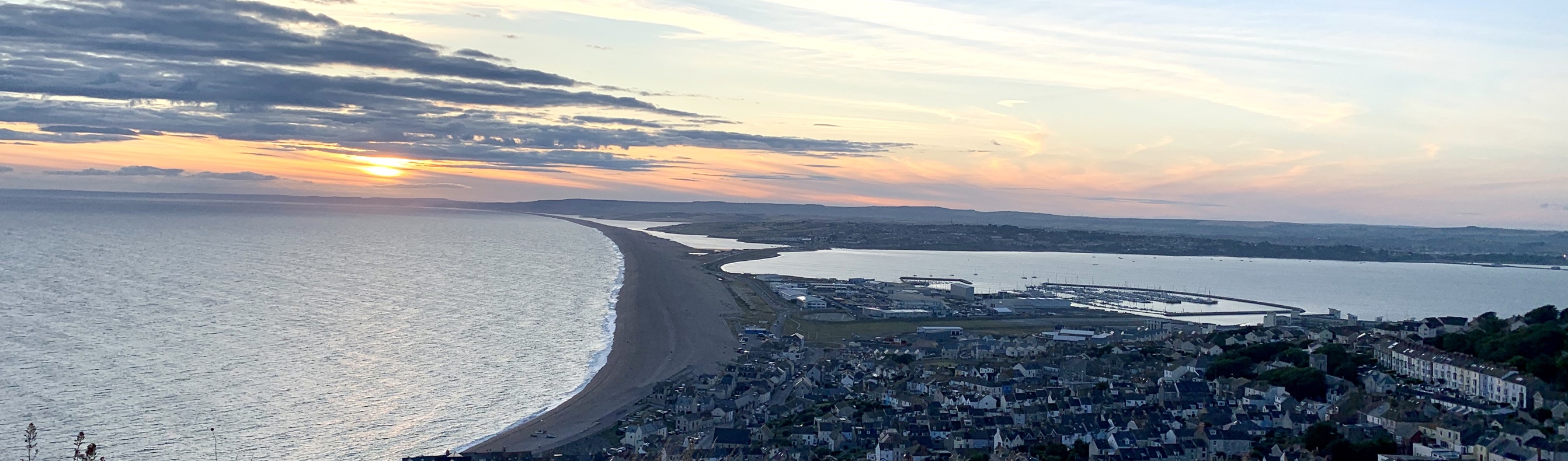The view of Weymouth and Chesil Beach from Portland Heights at sunset