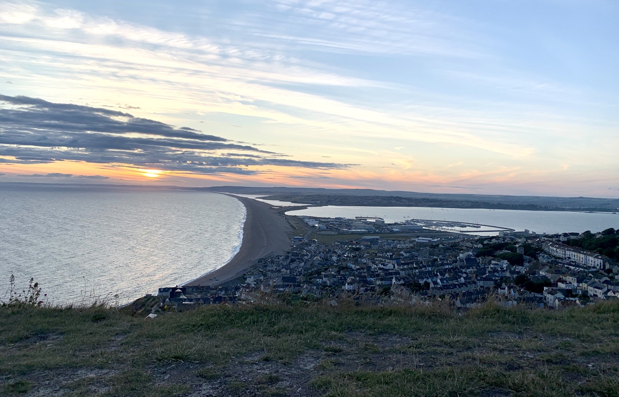 The view of Weymouth and Chesil Beach from Portland Heights at sunset