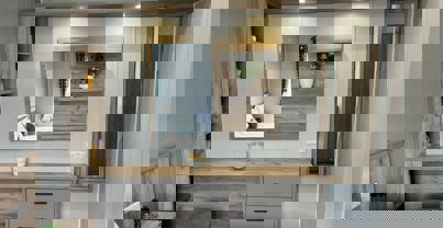 Dressing area in master bedroom with in-built storage and lighting