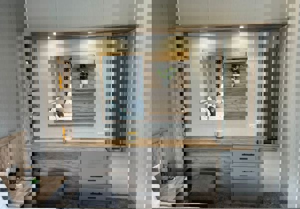 Dressing area in master bedroom with in-built storage and lighting