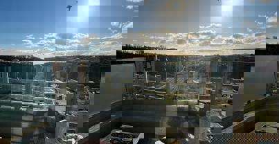 Sunken firepit on decking during day with views of valley