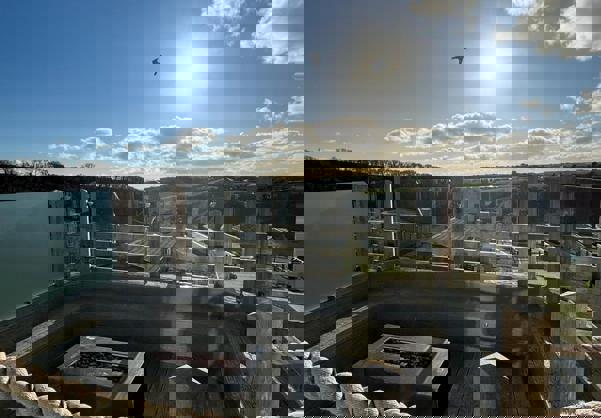 Sunken firepit on decking during day with views of valley