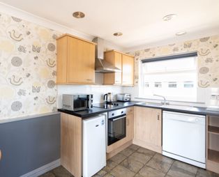 Open plan kitchen diner in Chesil Beach apartments 