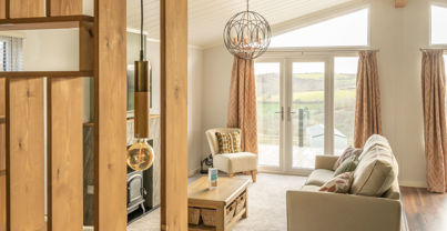 Lounge area with sofa, fireplace coffee table and patio doors
