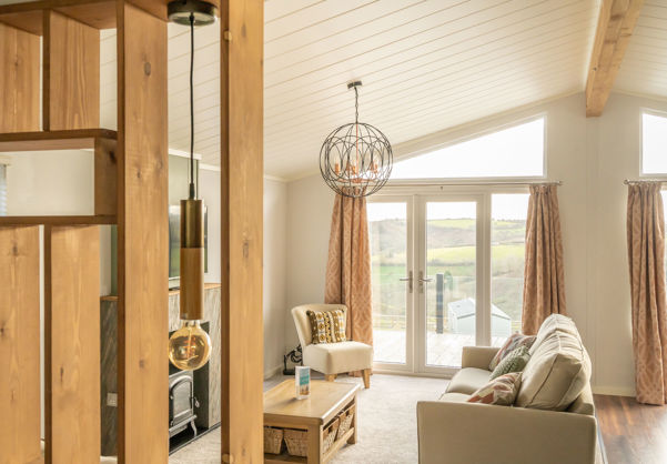 Lounge area with sofa, fireplace coffee table and patio doors