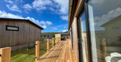 External of a luxury lodge on pitch with decking