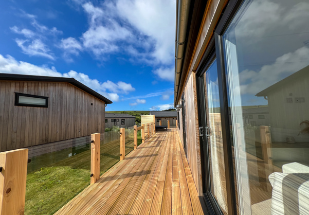 External of a luxury lodge on pitch with decking