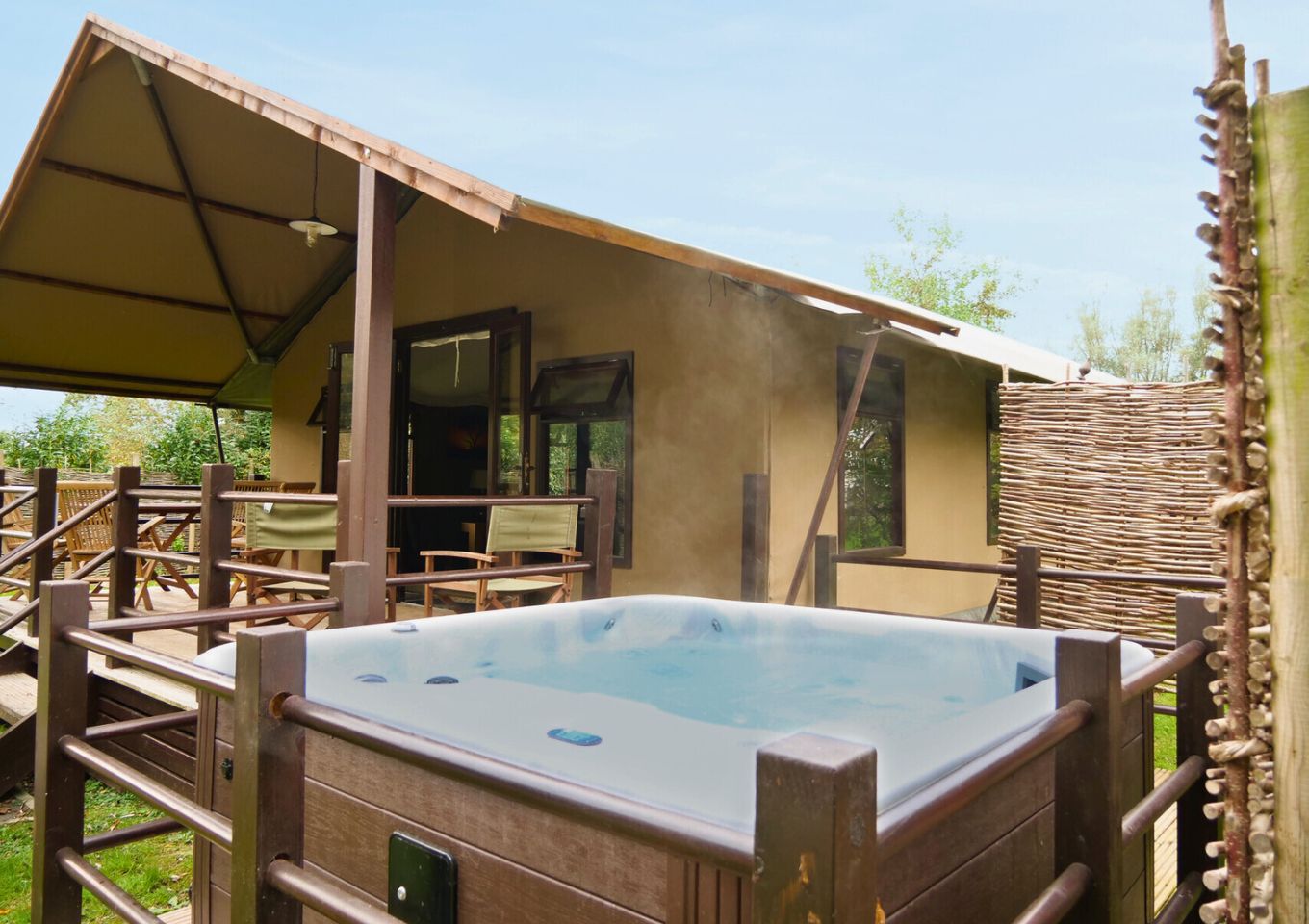 External of safari tent with hot tub and veranda