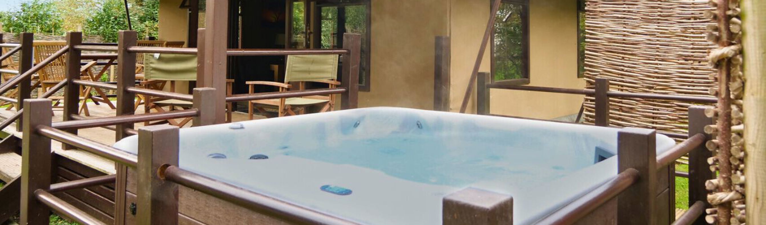 External of safari tent with hot tub and veranda