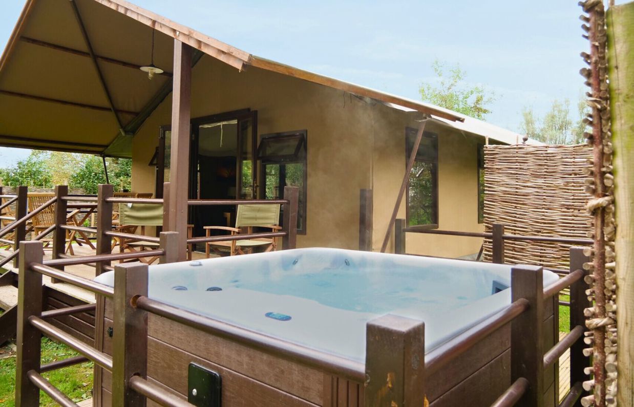 External of safari tent with hot tub and veranda