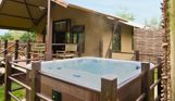 External of safari tent with hot tub and veranda