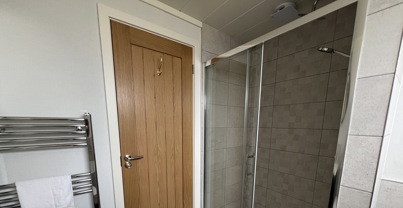 Large shower in main bathroom with stylish floor tiles